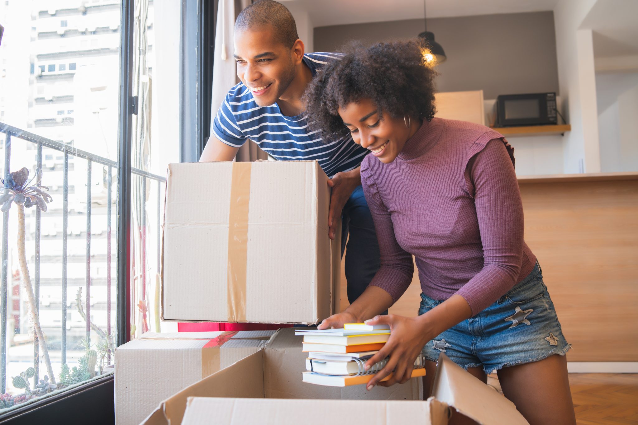 latin-couple-unpacking-at-their-new-house-J4S3MM8-2048x1366